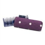 Photograph of a weekly pill box with a plum-colour with white spotty print fabric cover