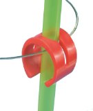 Image of a red Strawberi straw holder, holding a green straw attached to a glass