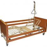 Image shows a photograph of a reclining, movable profiling bed with hoist